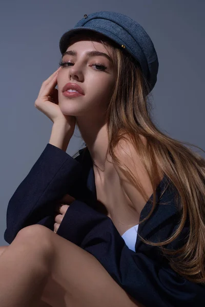 Seductive woman face. Sensual young woman posing in fashion cap hat. Beautiful sexy model. Beauty face. Sensual girl, sexy model portrait. Natural beauty