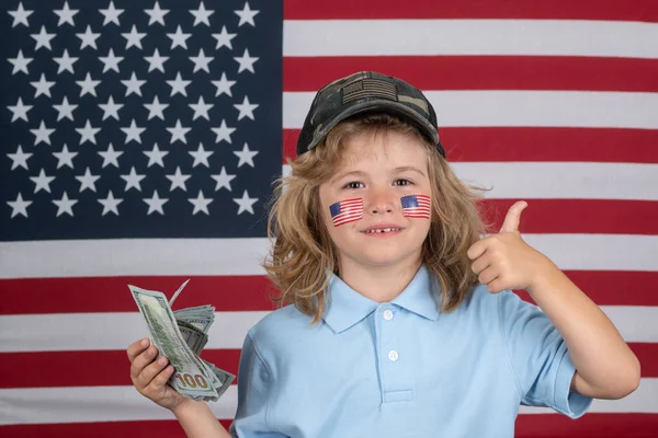 American dreams. Portrait of child with money banknotes. Kid with money. Children learning financial responsibility about saving money. Child with american flag cheek