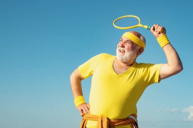 Badminton oynayan yaşlı bir adam. Sağlıklı yaşlı bir sporcunun portresi