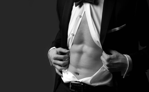 Nude male abs in black suit. Retro fashion. Formal classic suit. Elegant fashion