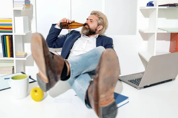 Businessman drinking beer in office, wide angle. Business man break for relax. Funny worker. Fun office worker going crazy of alcohol. Drunk addicted business manager getting up sitting in chair