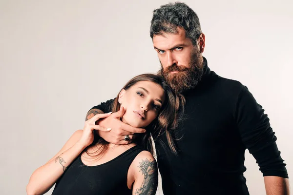 brutal bearded man and woman with tattoo. hairdresser and barbershop. tattoo salon. male beard care. hipster man with sexy girl. relationship. fashion couple. couple in love. brutal people.