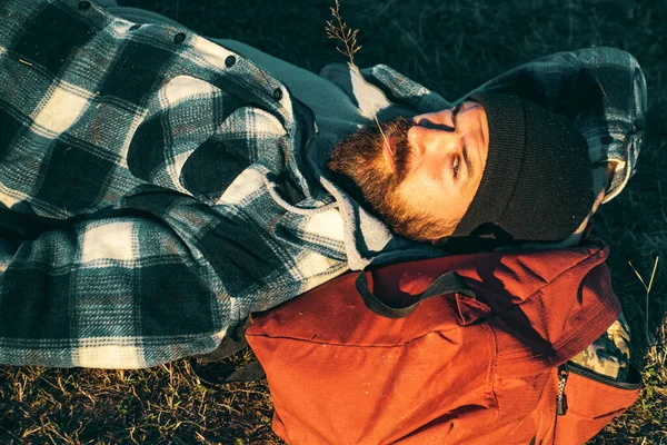 bearded man relax outdoor in sunset. hiking and camping. adventure traveling. Mature hipster with beard. brutal caucasian hipster with moustache. Bearded man. Confident brutal man relax on camping.
