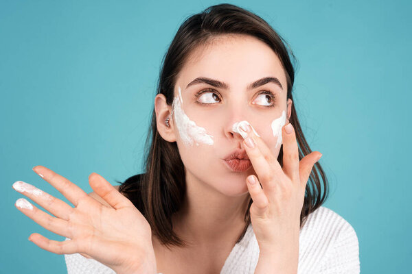 Beautiful girl model apply a cleansing mask on face