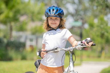 Child riding a bike in summer park. Children learning to drive a bicycle on a driveway outside. Kid riding bikes in the city wearing helmets as protective gear. Child on bicycle, bike outdoor clipart