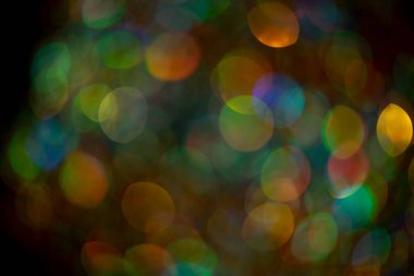 Hafif bulanık bokeh, odaklanmış arkaplan. Bokeh 'li şenlikli soyut arkaplan, sönmüş ışıklar. Şenlikli ışıltılı ışıklar arka plan, soyut ışıltılı arka plan tasarımı. Işık efektli arkaplan