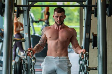 Portrait of handsome sporty man with muscular body doing weight lifting. Guy workout at gym. Fitness trainer, sport instructor, sporty man, fit model, sportsman workout. Power athletic guy bodybuilder