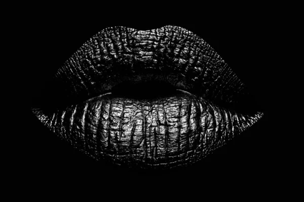Abstract gold lips. Golden lips closeup. Gold metal art lip. Beautiful makeup. Golden lip gloss on beauty female mouth, closeup. Mouth Icon