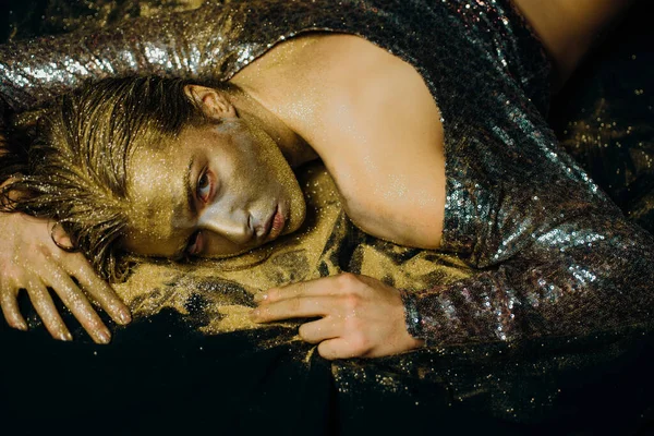 Golden skin. Sexy girl face makeup body art metallized color. Spa wellness. Richness and wellbeing. Golden mask. Luxury beauty procedure. Golden lady relaxing. Pure gold. Vogue and glamour concept.