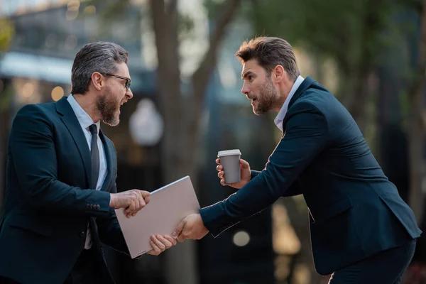 Business fight. Businessmen fighting outdoor. Angry office workers in city. Disagreed men partners. Business competition. Businessmen have business conflict. Business men aggressive outdoor