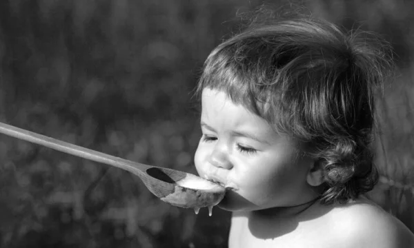 Feeding Baby Big Spoon Outdoor Green Grass — Stock Photo, Image