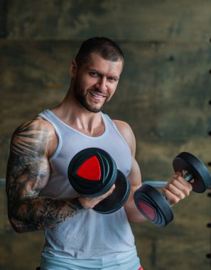 Muscular athletic fit man hard workout fitness in gym. Sport fitness and bodybuilding. Strong muscular doing exercise in the gym. Sexy muscular male body. Fitness man in the gym. Fitness training