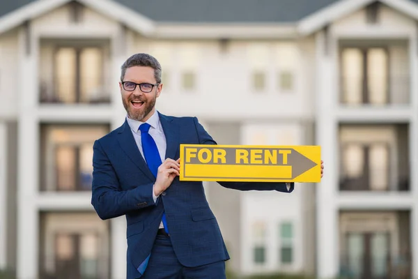 Real estate agents hold sign for rent. Real estate trading ideas and bank loans for renting and selling houses and land. Rental house