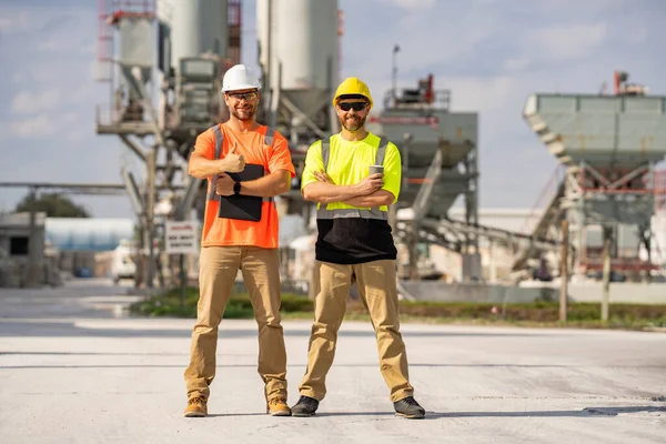 Professional heavy industry engineer workers in safety uniform and hard hat helmet. Factory engineer. Manufacturing facility working. Heavy industry manufacturing factory workers
