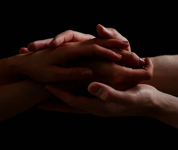 Concept of salvation. Hands of two people rescue, help. Helping hand, support. Isolated arm on black, charity. Devoted and empathy. Couple relationship