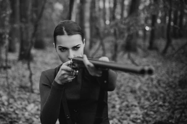 Hunter woman with shotgun on hunt. Hunting in forest. Portrait of woman Hunter. Closed and open hunting season. Autumn hunting season. Hunting