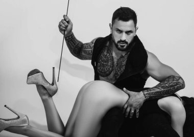 Wild sex, love game, bdsm. Satisfied and enjoying romantic moment. Beautiful young couple hugging sensual in studio