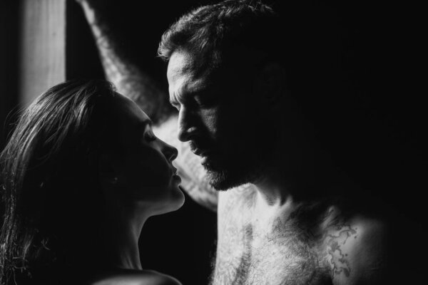 Sexy couple in love. Romantic couple in love looking at each other. Sensual passionate couple gently kissing, enjoying tenderness and intimacy. Young sexy affectionate coupl