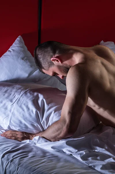 Mans naked body, muscular shoulders. Naked man in bed. Muscular sexy male bum. Gay sexy model. Muscular sexy man with naked torso. Hunk with athletic body. Carefree guy enjoying night