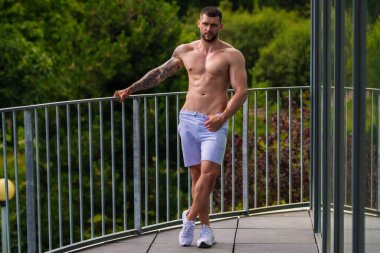 Fit guy doing exercise at gym. Handsome sporty man workout with with dumbbells on gym. Male athlete with dumbbell on fitness workout. Fitness man in gym. Muscular sportsman workout with weight in gym