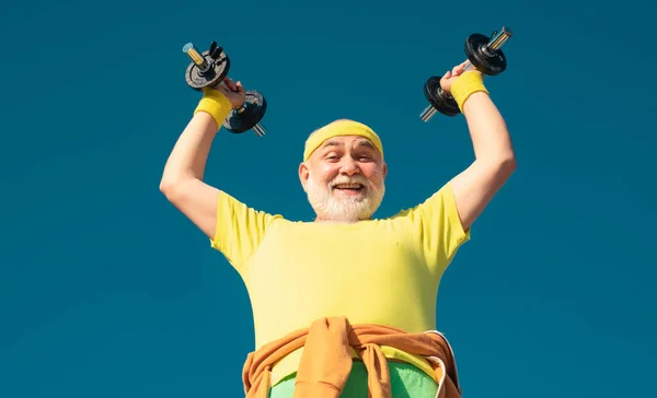 Old Man Holding His Hands Front Him While Lifting Dumbbells — Stock Photo, Image