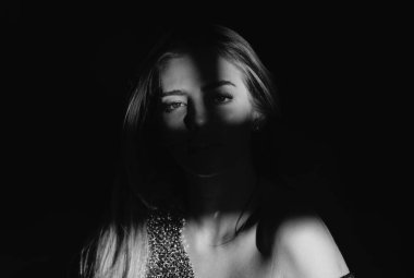 Çekici ve şehvetli görünen güzel kadın modelinin portresi. Siyaha izole edilmiş dramatik stüdyo ışığı olan güzel bir yüz. Tutkulu bir kız, çekici bir kadın model. Güzellik salonu