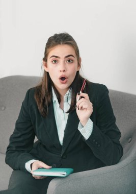 Surprised young businesswoman working on laptop with too much work in office. Secretary girl