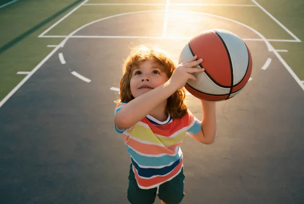 stock image Happy little boy kid playing basketball on playground. Sport for kids