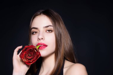 Beauty girl with red rose. Beautiful sensual woman hold flowers, studio portrait