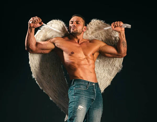 Muscle strong beautiful stripped male angel. Handsome young athletic man with a naked torso looks like an angel with white wings. Valentines day
