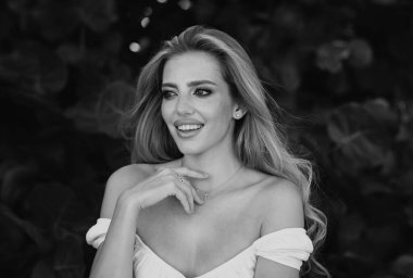 Güzel, narin, genç bir kadın, açık havada şehvetli görünüyor. İlkbaharda ya da yaz döneminde alımlı, zarif ve seksi bir bayan. Güzel genç kız bahar parkında dinleniyor.