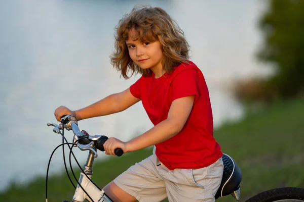 stock image Child on bicycle. Boy in a helmet riding bike. Little cute caucasian boy in safety helmet riding bike in city park. Child first bike. Kid outdoors summer activities. Kid on bicycle. Boy ride a bike