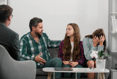 Family at psychology session. Psychologist with young couple, psychotherapist or marriage counselor listen mental health of couple and child. Father and mother with daughter at psychology session clipart