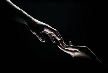 Two hands at the moment of farewell. Romantic touch with fingers, love. Help friend through a tough time. Rescue gesture, support, friendship and salvation concept. Man and woman holding hands