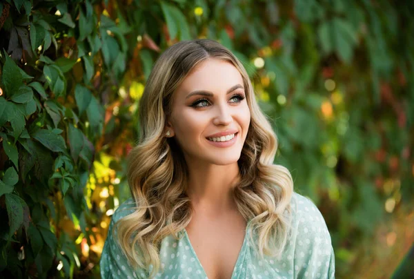 stock image Portrait of young woman looking eways in summer park outdoor. Romantic girl with beauty face. Woman with romantic smile. Lifestyle, walk outdoors, enjoying life, positivity