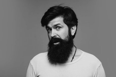 Şaşırmış yakışıklı adam. Berber dükkanında uzun sakallı ve bıyıklı bir berber. Sakallı hippi.