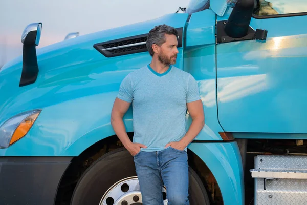 Men driver near lorry truck. Man owner truck . Serious middle aged man trucker trucking owner. Transportation industry vehicles. Handsome man driver front of truck