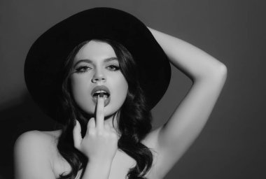 Sexy woman licking middle finger. Fuck you concept. Offensive gesture. Middle finger girl