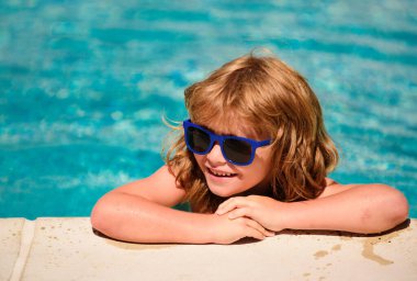 Yaz havuzunda bir çocuk. Yaz çocukları hafta sonu. Güneş gözlüklü mutlu çocuk. Havuzdaki çocuk. Yaz tatili