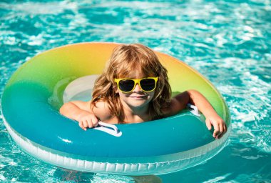 Yüzme havuzunda yaz tatili çocuğu. Çocuk Aquapark 'ta eğleniyor. Şişme lastik çemberdeki komik çocuk. Yaz zamanı. Çekim konsepti