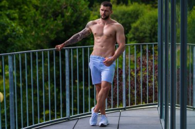 Handsome fit muscular caucasian man workout in the gym with weight pumping up muscles. Fitness and bodybuilding sport. Bodybuilder with dumbbells at gym, hard workout