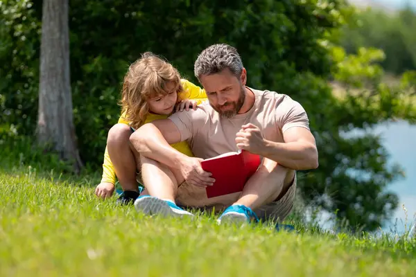 Father Son Sitting Green Grass Garden Reading Book Together Happy — Stock Photo, Image