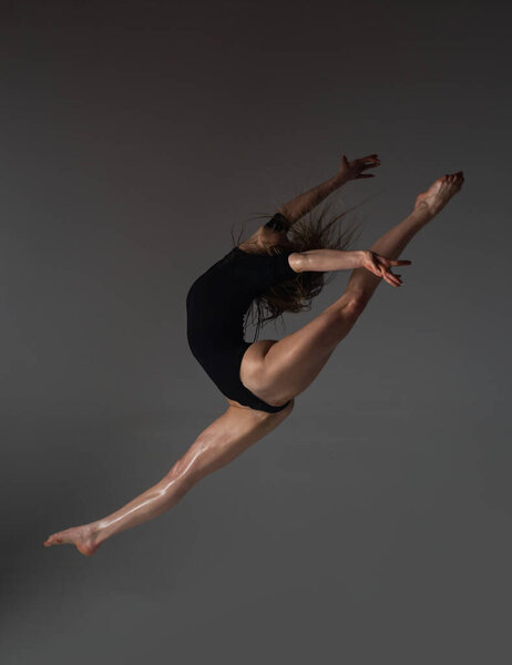 Leg-split jump. Flexible woman. Fit girl stretching and dancing. Stretching sexy flexible body. Flexible woman gymnast. Inspiration. Graceful ballet dancer. Art, motion, flexibility concept