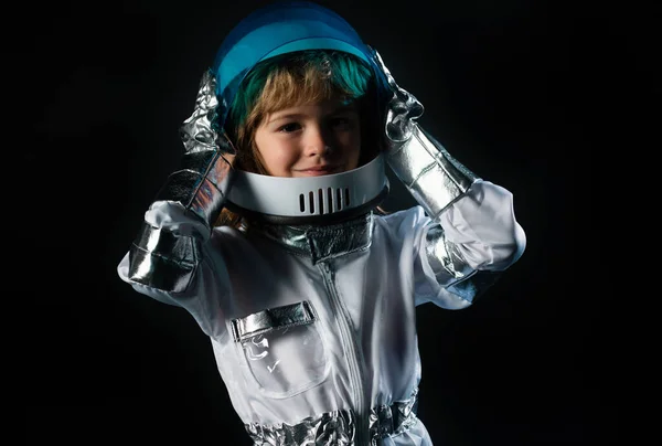 Boy playing to be an astronaut with space helmet and metal suit. Child boy playing with space helmet, little astronaut or spaceman
