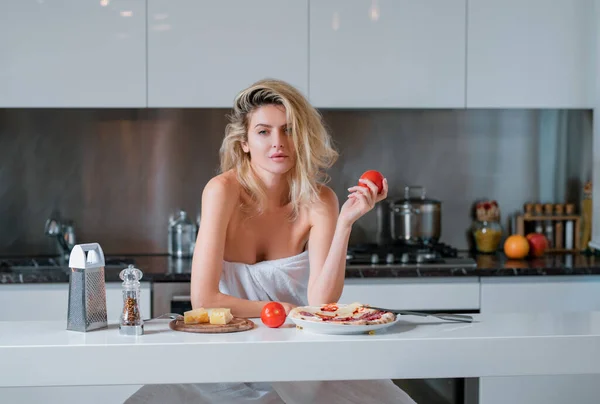 朝台所で主婦が料理をしている チーズ ソーセージ トマトのための成分を持つ女性 — ストック写真