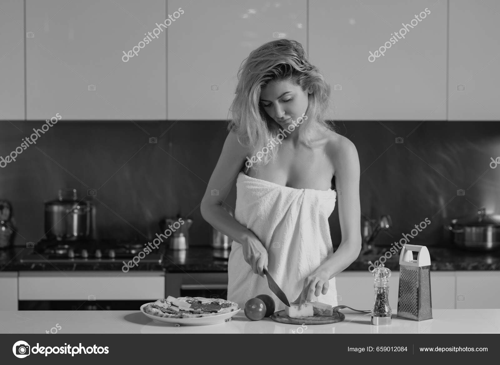 Bare breast. Beautiful woman drink coffee near table on kitchen at