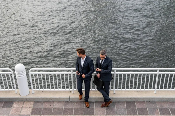 stock image Business communication and discussion. Business man sharing his experience. Business partners meeting outdoor. Two confident business people in formalwear discussing something while sitting at street