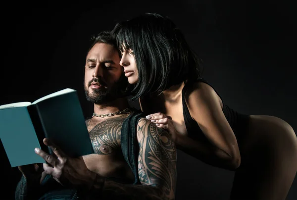 Couple in love reading book. Romantic lovers