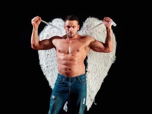 Sexy angel cupid man with angels wings for Valentines Day. Muscle strong beautiful stripped male angel. Handsome young athletic man with a bare torso looks like an angel with white wings