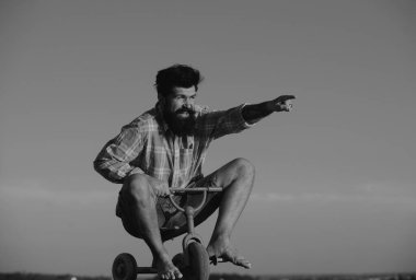 Küçük bir bisiklet süren çılgın bir adam. Bisiklet süren komik bir adam.